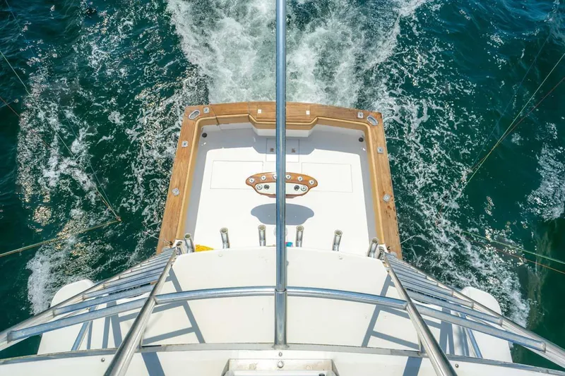 Slide: The Image of 1993 Buddy Davis Express Custom Carolina boat cruising on open water, viewed from above. - 19