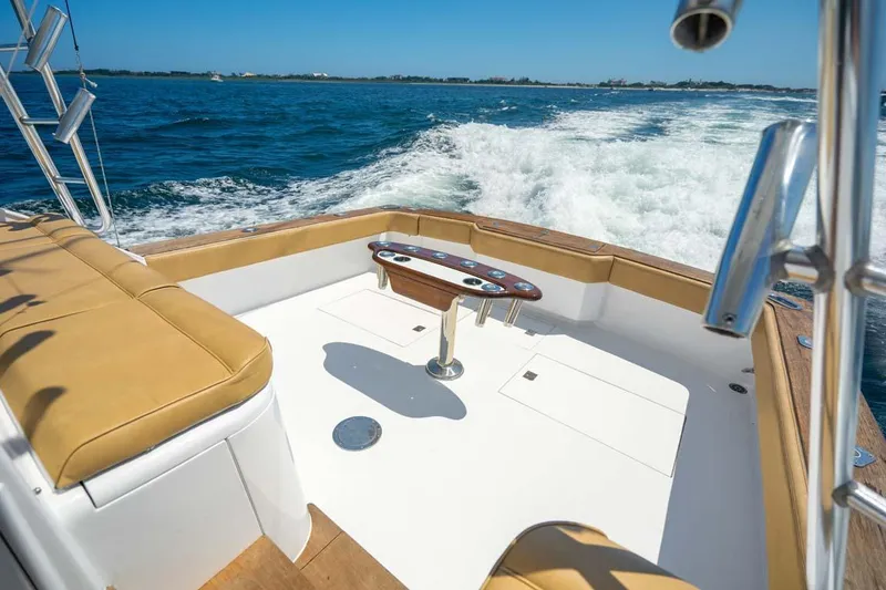 Slide: The Image of 1993 Buddy Davis Express Custom Carolina boat cruising on open water. - 23