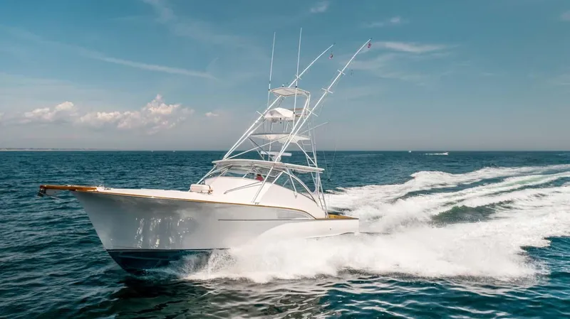 Slide: The Image of 1993 Buddy Davis Express Custom Carolina yacht cruising on open sea. - 24