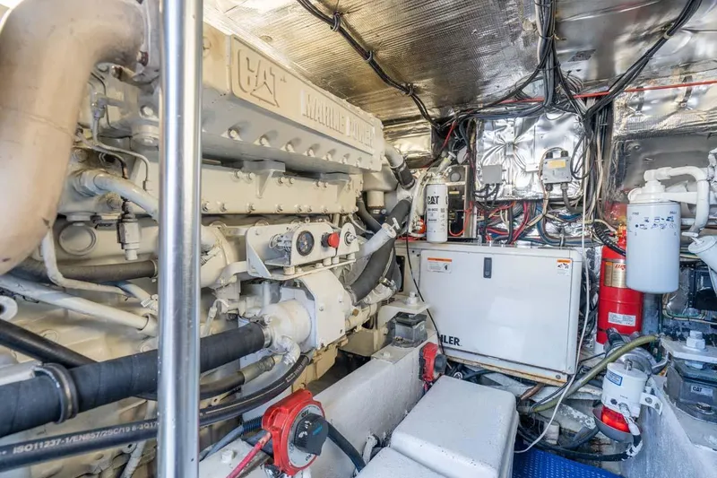 Slide: The Image of Engine room of 1993 Buddy Davis Express Custom Carolina boat, showcasing machinery and wiring. - 26