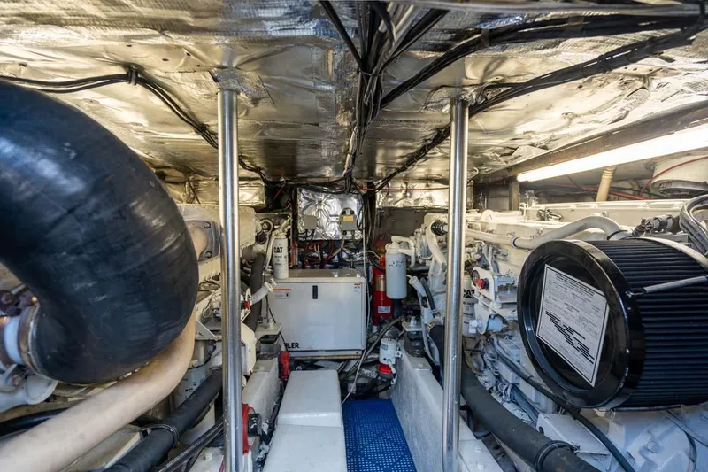 Slide: The Image of Engine room of 1993 Buddy Davis Express Custom Carolina boat, showcasing mechanical components and systems. - 27