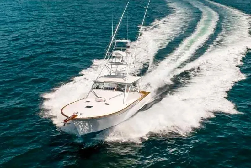 Slide: The Image of 1993 Buddy Davis Express Custom Carolina yacht cruising on open water. - 4