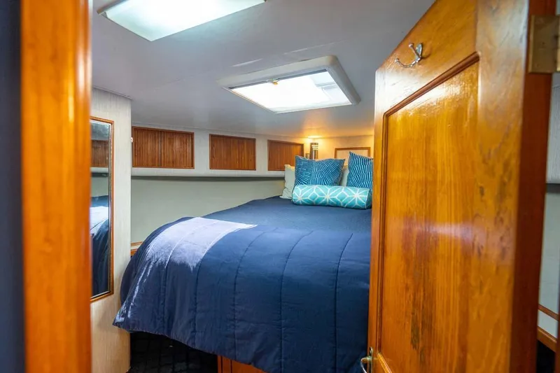 Slide: The Image of Cozy cabin interior of 1993 Buddy Davis Express Custom Carolina boat with blue bedding. - 9