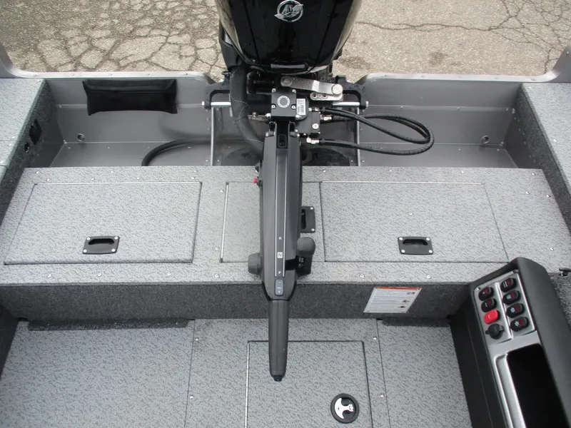 Slide: The Image of 2025 Lund Pro Guide 1875 boat interior with motor and control panel. - 10