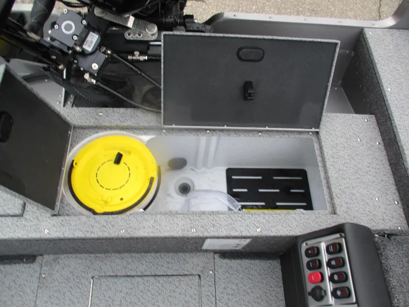 Slide: The Image of 2025 Lund Pro Guide 1875 boat interior with storage compartments and control panel. - 11