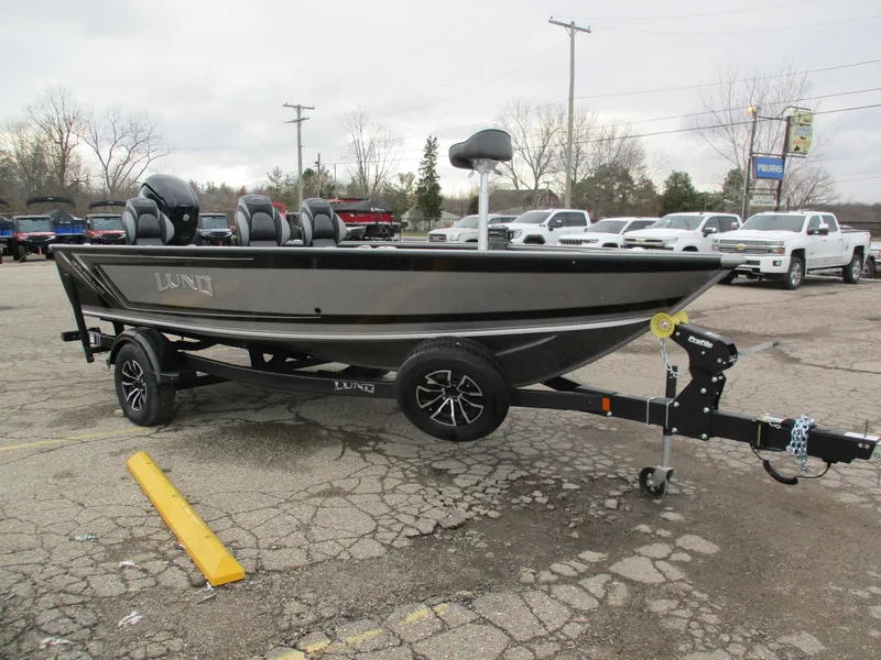 Slide: The Image of 2025 Lund Pro Guide 1875 fishing boat on trailer in parking lot. - 12