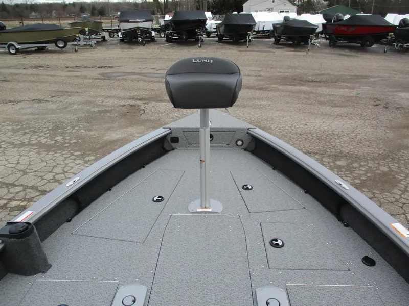 Slide: The Image of 2025 Lund Pro Guide 1875 boat interior with seat, parked on a lot. - 14
