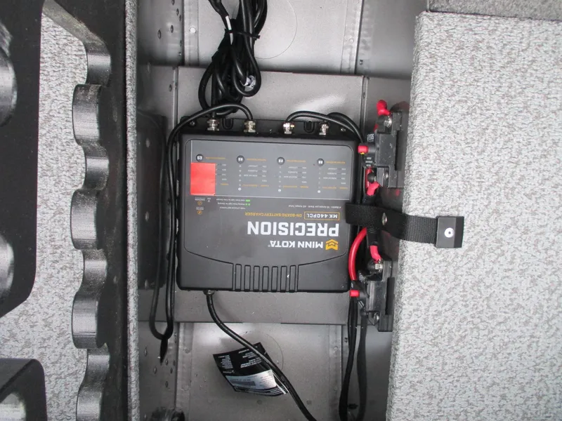 Slide: The Image of Minn Kota Precision charger in 2025 Lund Pro Guide 1875 boat compartment. - 15