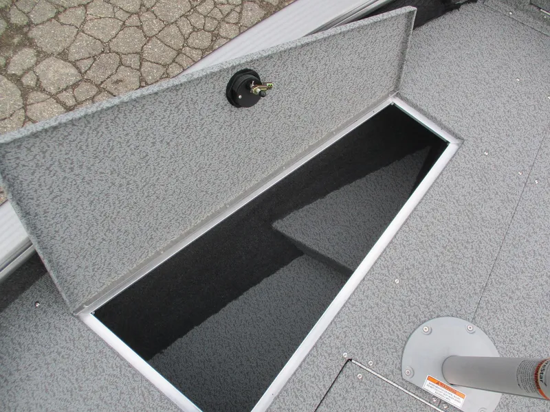 Slide: The Image of 2025 Lund Pro Guide 1875 boat storage compartment open on deck. - 18