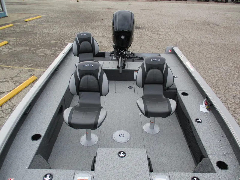 Slide: The Image of 2025 Lund Pro Guide 1875 boat interior with four seats and motor. - 19
