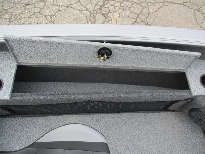 Slide: The Image of 2025 Lund Pro Guide 1875 boat storage compartment with open lid, showcasing interior space. - 21