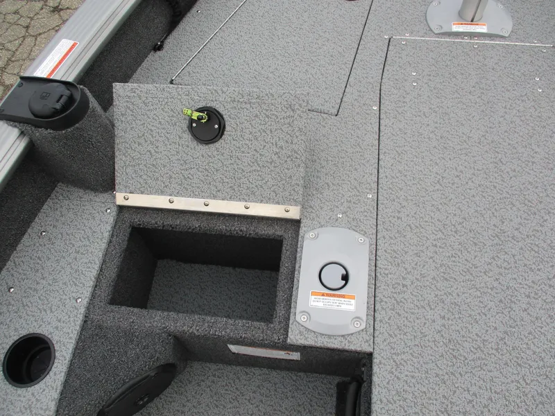 Slide: The Image of 2025 Lund Pro Guide 1875 boat interior with storage compartments and textured flooring. - 4