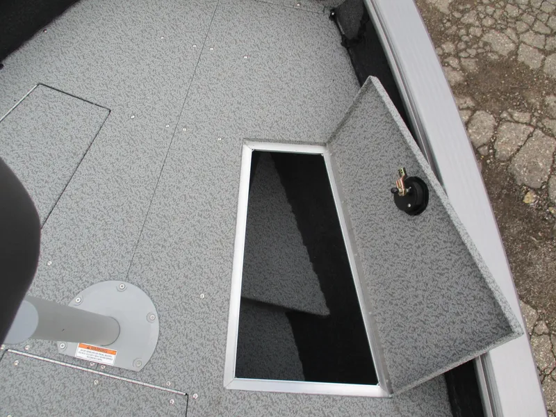 Slide: The Image of 2025 Lund Pro Guide 1875 boat storage compartment with open hatch. - 6
