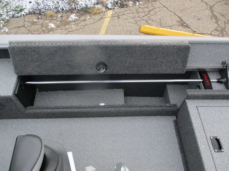 Slide: The Image of 2025 Lund Pro Guide 1875 boat interior storage compartment with rod holder. - 9