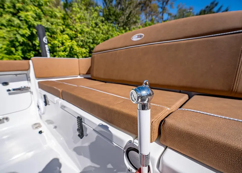 Slide: The Image of 2025 Sea Hunt Ultra 255 SE boat interior with tan seating and chrome fixtures. - 12