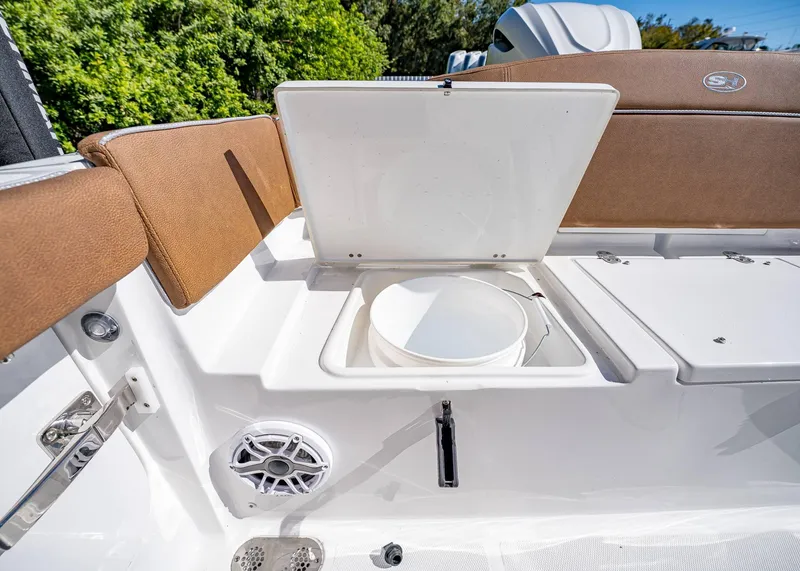 Slide: The Image of 2025 Sea Hunt Ultra 255 SE boat interior with open storage compartment and seating. - 14