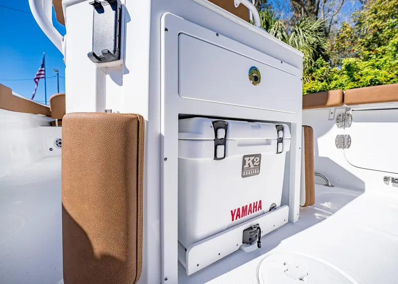 Slide: The Image of 2025 Sea Hunt Ultra 255 SE boat interior with K2 cooler and Yamaha branding. - 16