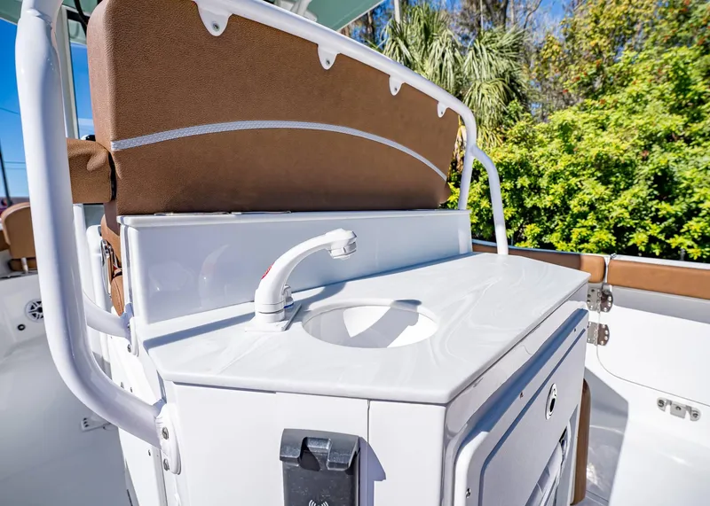 Slide: The Image of 2025 Sea Hunt Ultra 255 SE boat interior with sink and seating. - 17