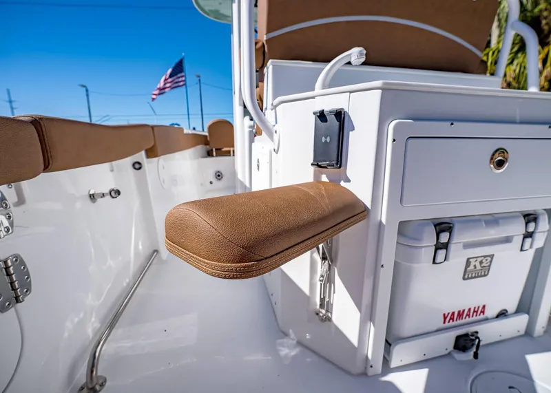 Slide: The Image of 2025 Sea Hunt Ultra 255 SE boat interior with seating and storage, American flag in background. - 19