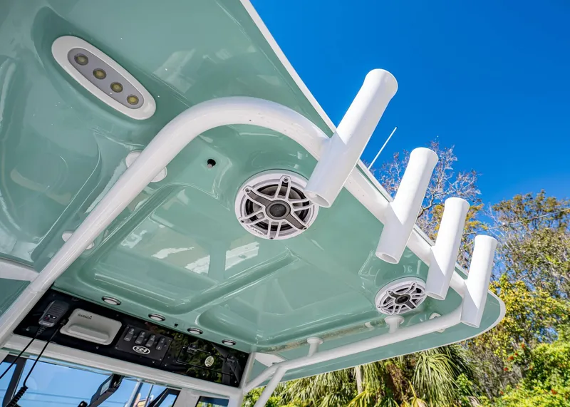Slide: The Image of 2025 Sea Hunt Ultra 255 SE boat roof with rod holders and speakers. - 23