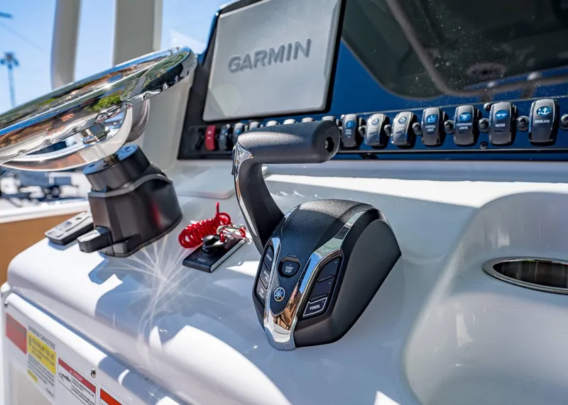 Slide: The Image of Close-up of 2025 Sea Hunt Ultra 255 SE boat controls with Garmin display. - 28