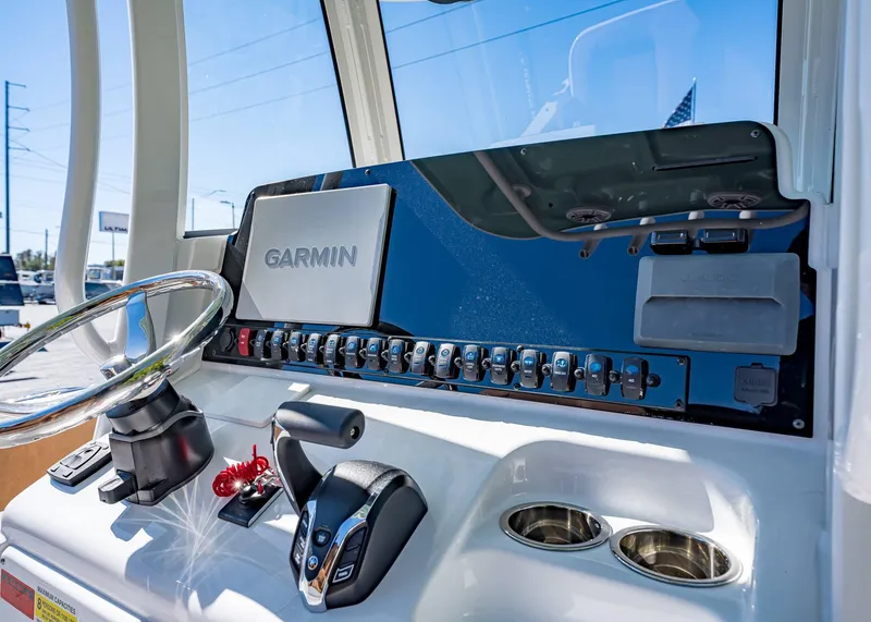 Slide: The Image of 2025 Sea Hunt Ultra 255 SE dashboard with Garmin navigation system and controls. - 29