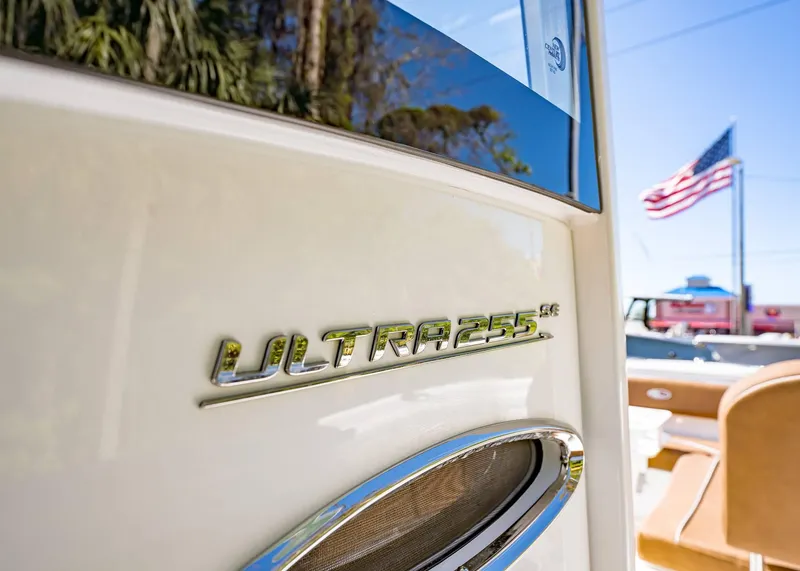 Slide: The Image of 2025 Sea Hunt Ultra 255 SE boat with American flag in background. - 30