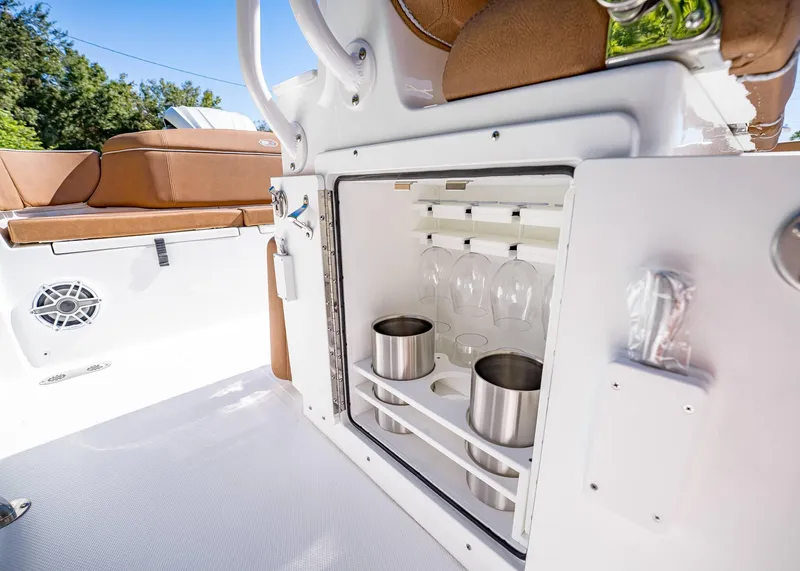 Slide: The Image of 2025 Sea Hunt Ultra 255 SE boat interior with built-in drink storage. - 31