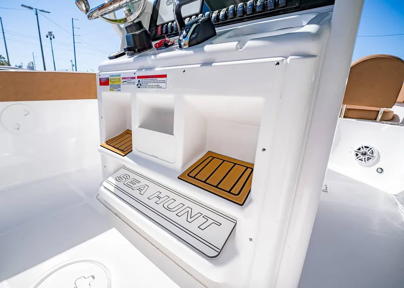 Slide: The Image of 2025 Sea Hunt Ultra 255 SE boat interior with console and storage compartments. - 33