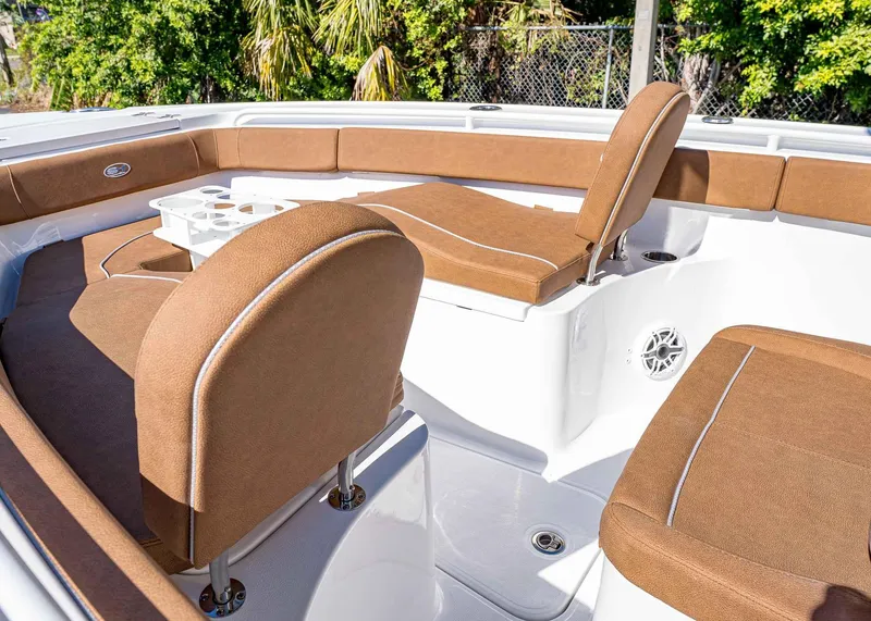 Slide: The Image of 2025 Sea Hunt Ultra 255 SE boat interior with brown cushioned seating. - 38