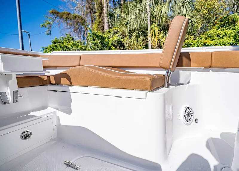 Slide: The Image of 2025 Sea Hunt Ultra 255 SE boat interior with tan seating and white deck. - 39