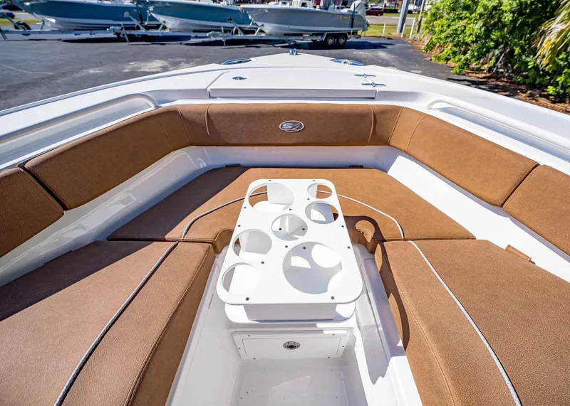 Slide: The Image of 2025 Sea Hunt Ultra 255 SE boat interior with brown seating and cup holders. - 42