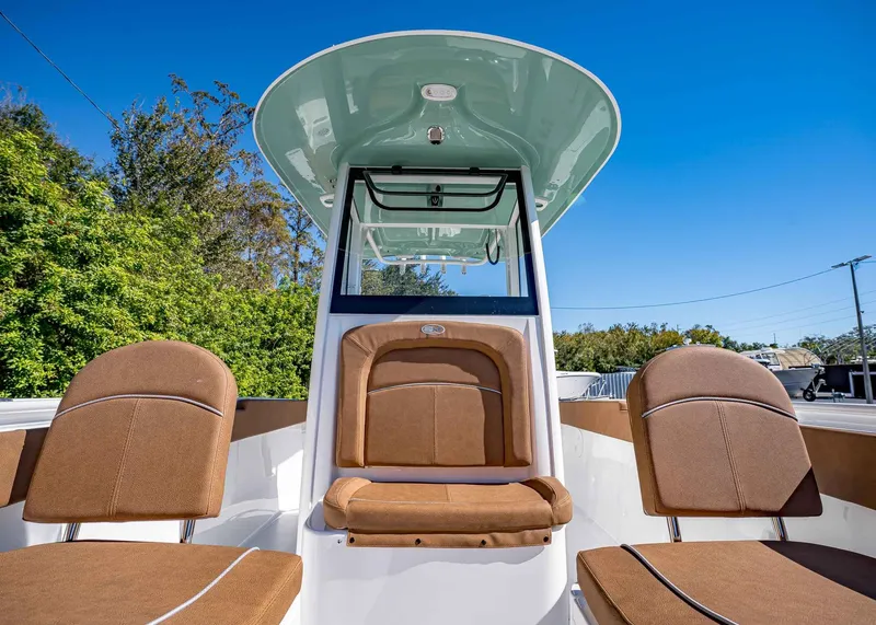 Slide: The Image of 2025 Sea Hunt Ultra 255 SE boat interior with brown seating and canopy. - 43