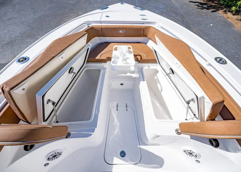 Slide: The Image of 2025 Sea Hunt Ultra 255 SE boat interior with open storage compartments and seating. - 44