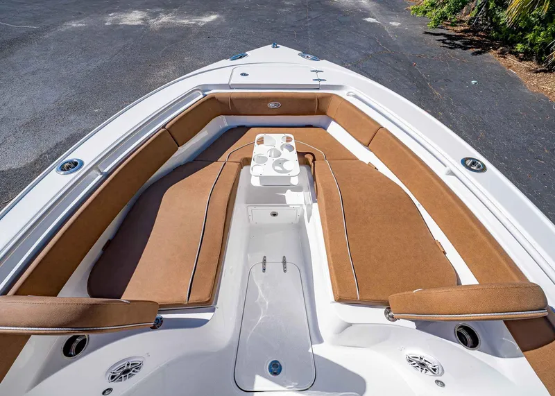 Slide: The Image of 2025 Sea Hunt Ultra 255 SE boat with brown cushioned seating and cup holders. - 45