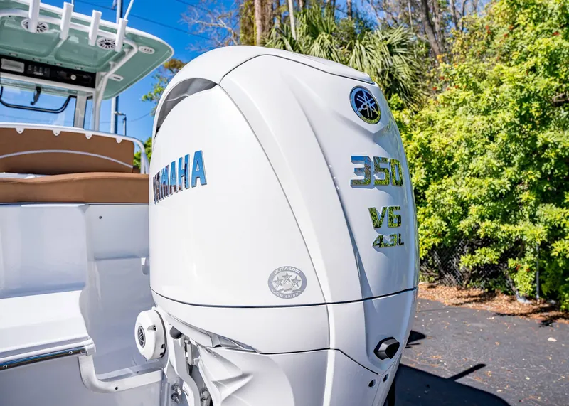 Slide: The Image of 2025 Sea Hunt Ultra 255 SE with Yamaha 350 V6 engine, outdoors. - 7