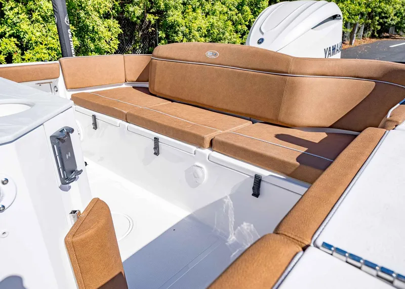 Slide: The Image of 2025 Sea Hunt Ultra 255 SE boat interior with tan cushioned seating. - 9