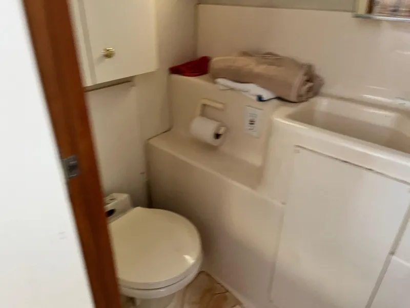 Slide: The Image of Bathroom in 1998 Silverton 322 Motor Yacht with toilet and sink. - 14