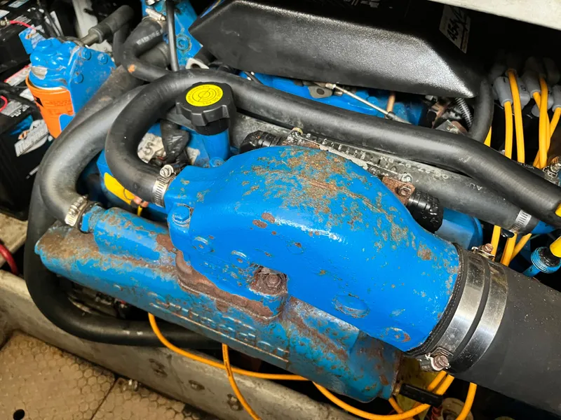 Slide: The Image of Close-up of a 1998 Silverton 322 Motor Yacht engine with blue components and visible wear. - 18