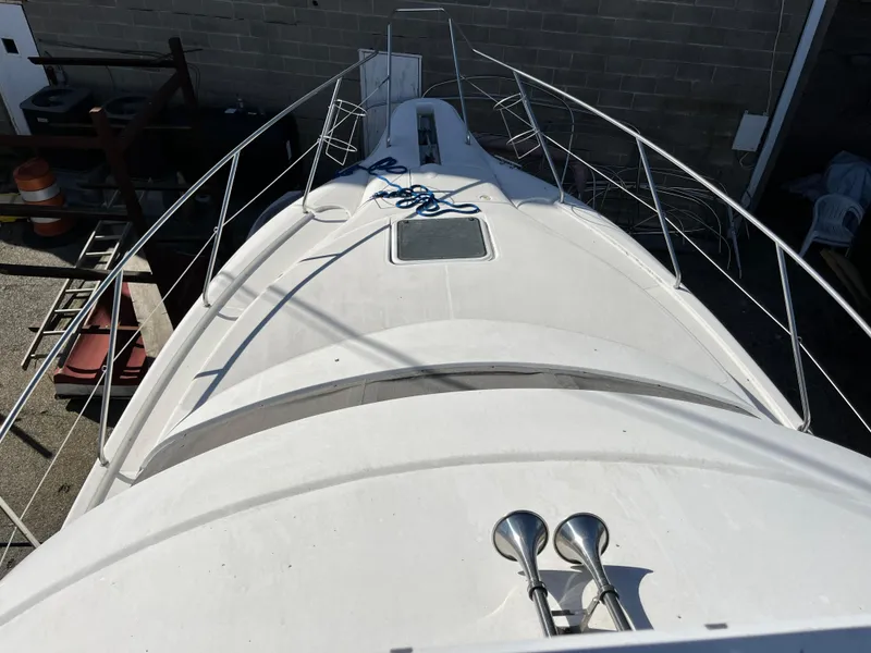 Slide: The Image of 1998 Silverton 322 Motor Yacht deck view with railing and ropes. - 7