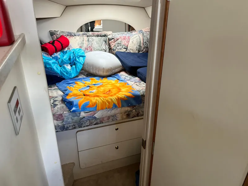 Slide: The Image of Cozy cabin interior of 1998 Silverton 322 Motor Yacht with vibrant sunflower blanket. - 9