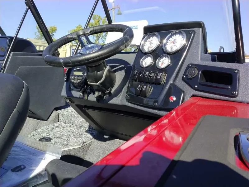 Slide: The Image of 2025 Tracker Targa V-18 WT boat dashboard with steering wheel and instrument panel. - 3