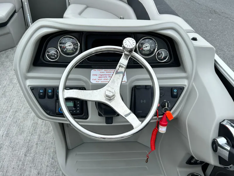 Slide: The Image of 2024 Berkshire 24RFC LE 2.75 boat dashboard with steering wheel and gauges. - 11