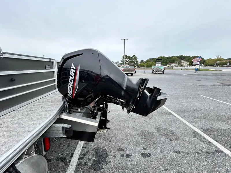 Slide: The Image of 2024 Berkshire 24RFC LE 2.75 with Mercury outboard motor in parking lot. - 16