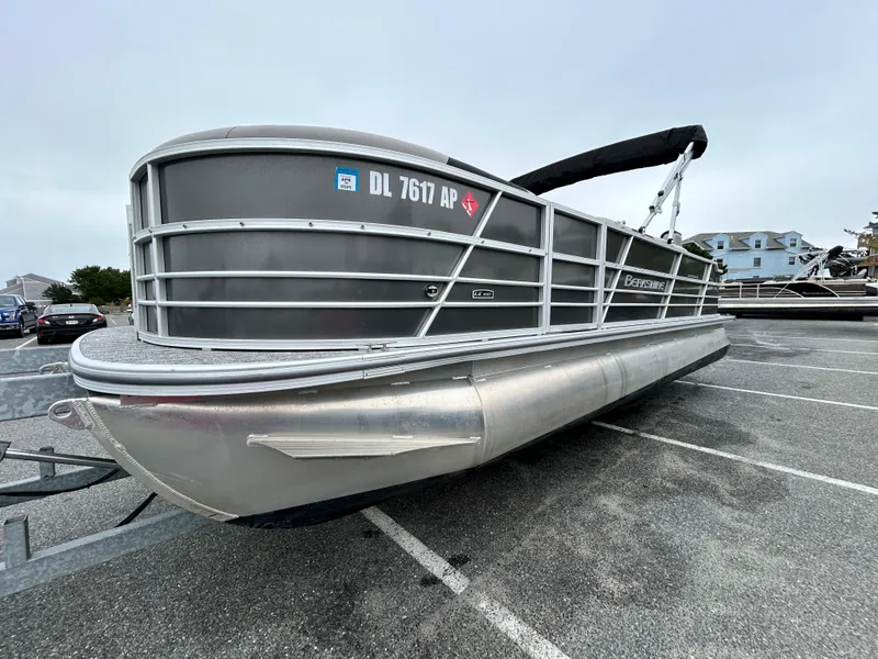 Slide: The Image of 2024 Berkshire 24RFC LE 2.75 pontoon boat in parking lot. - 2