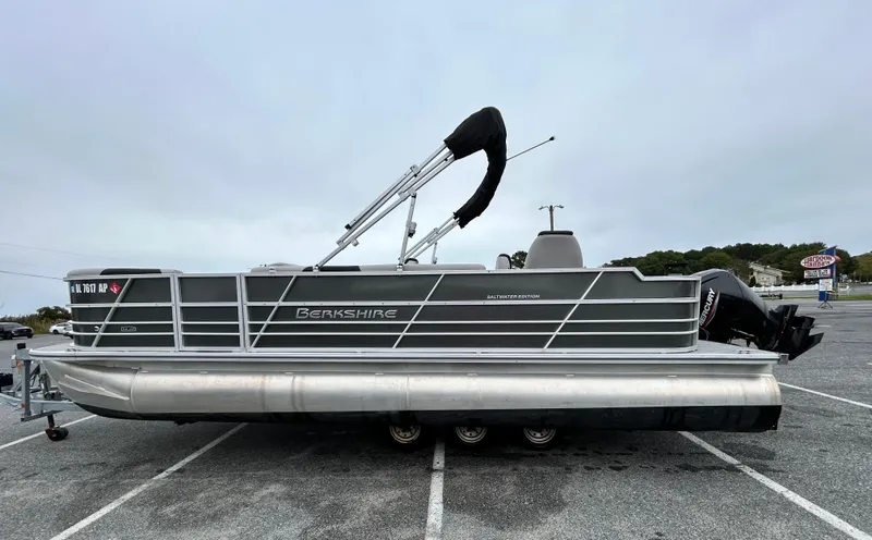 Slide: The Image of 2024 Berkshire 24RFC LE 2.75 pontoon boat parked on asphalt lot. - 3
