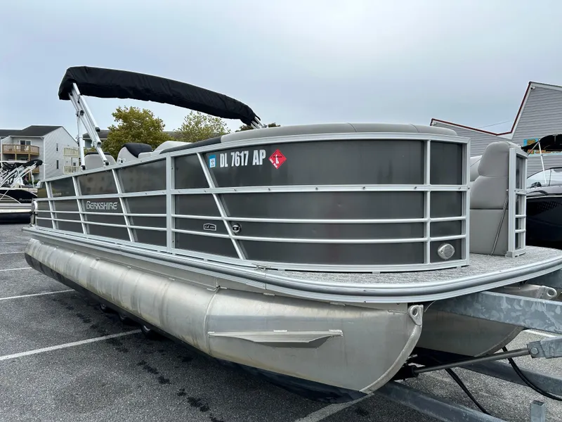 Slide: The Image of 2024 Berkshire 24RFC LE 2.75 pontoon boat in a parking lot. - 4