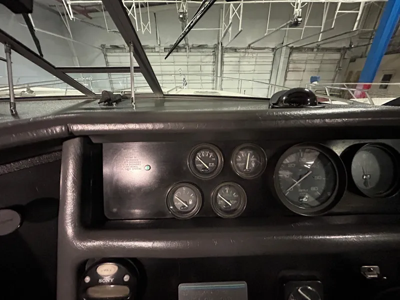Slide: The Image of Dashboard of a 1992 Sea Ray 370 Sundancer boat with gauges and controls. - 14