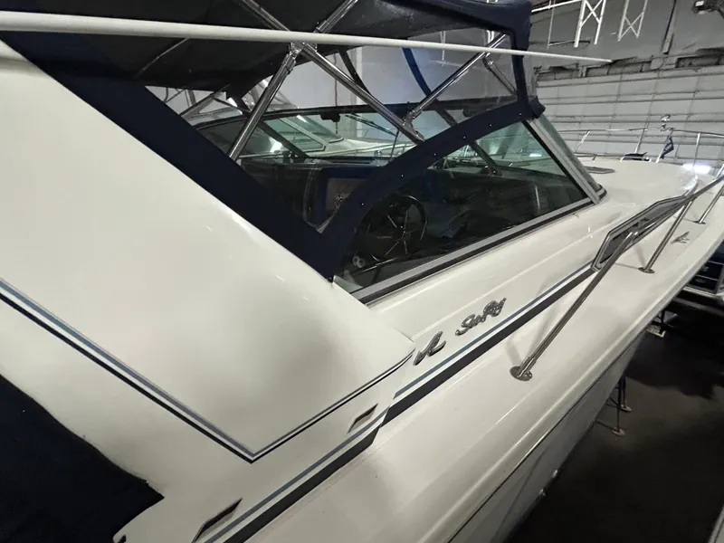 Slide: The Image of 1992 Sea Ray 370 Sundancer boat with blue canopy in storage facility. - 18