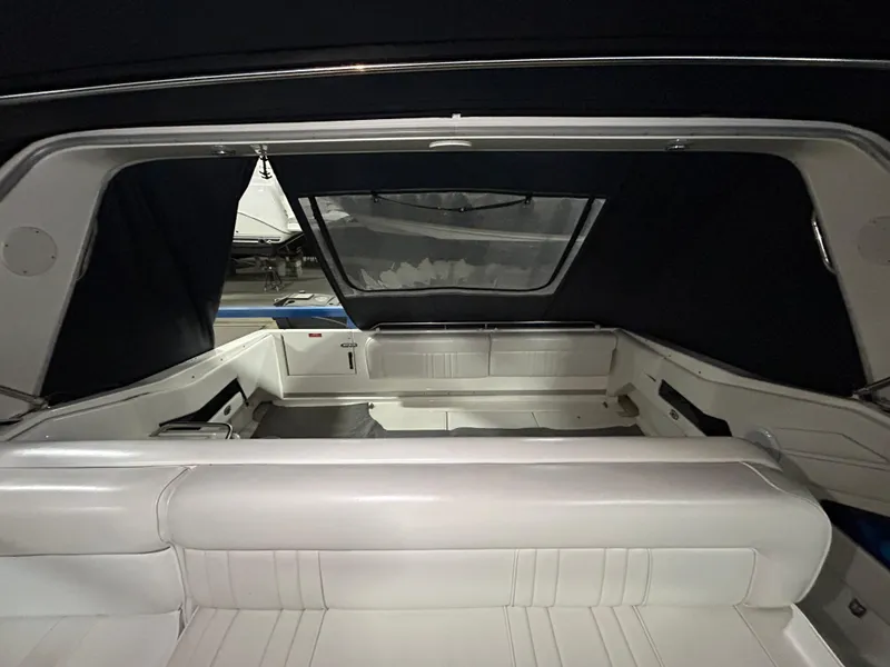 Slide: The Image of Interior view of 1992 Sea Ray 370 Sundancer boat with white seating and dark canopy. - 27